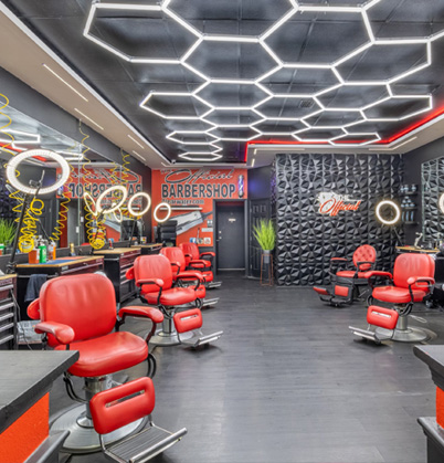 Interior of The Official Barbershop in Clearwater with red barber chairs